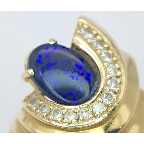 121 - A Gorgeous 18K Yellow Gold (tested) Australian Black Opal and Diamond Ring. An enticing oval cut opa... 