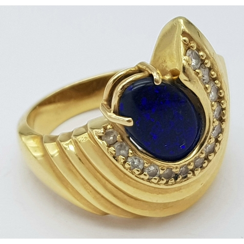 121 - A Gorgeous 18K Yellow Gold (tested) Australian Black Opal and Diamond Ring. An enticing oval cut opa... 