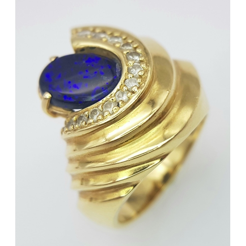 121 - A Gorgeous 18K Yellow Gold (tested) Australian Black Opal and Diamond Ring. An enticing oval cut opa... 