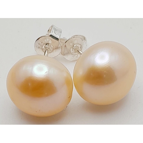 153 - A statement five row pink, cultured pearl necklace accompanied by a pair of pink pearl stud earrings... 