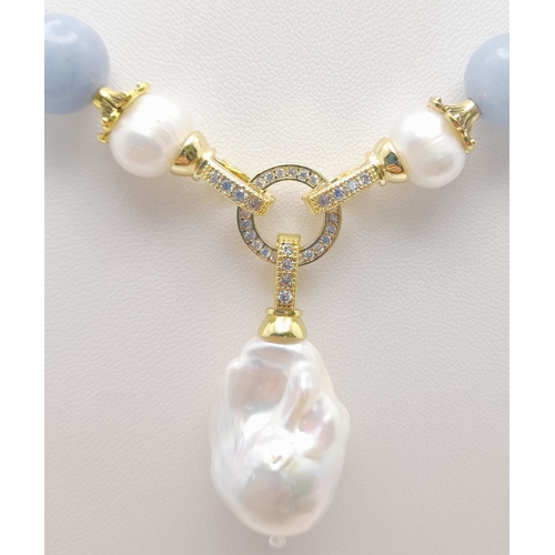 288 - A Blue Aquamarine Beaded Necklace with a Hanging Keisha Baroque Pearl Pendant. Gilded clasp. White s... 