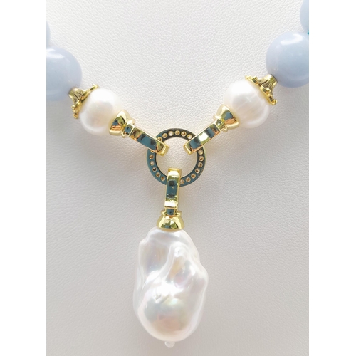 288 - A Blue Aquamarine Beaded Necklace with a Hanging Keisha Baroque Pearl Pendant. Gilded clasp. White s... 