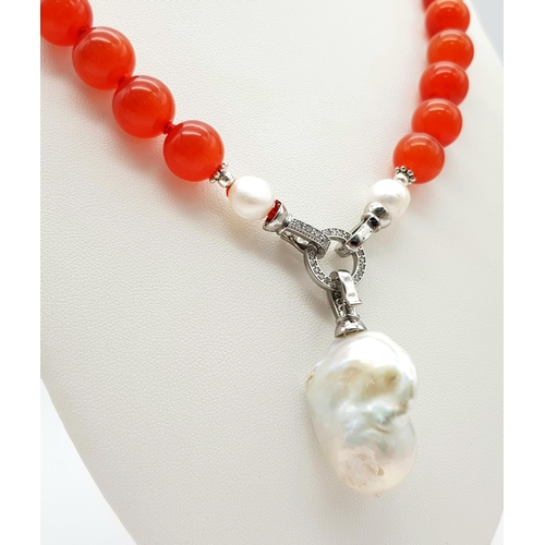 317 - A Deep Orange Cat's Eye Beaded Necklace with a Hanging Keisha Baroque Pearl Pendant. 12mm beads. Pen... 