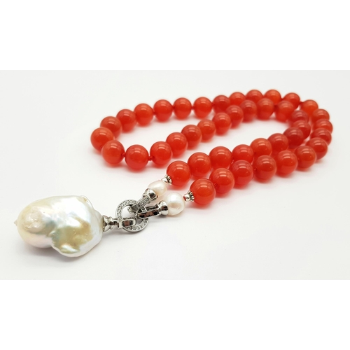 317 - A Deep Orange Cat's Eye Beaded Necklace with a Hanging Keisha Baroque Pearl Pendant. 12mm beads. Pen... 