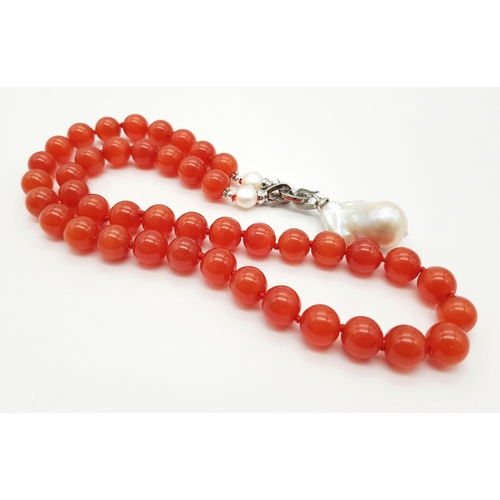 317 - A Deep Orange Cat's Eye Beaded Necklace with a Hanging Keisha Baroque Pearl Pendant. 12mm beads. Pen... 