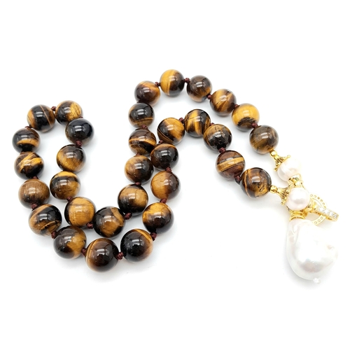 342 - A Rich Tigers Eye Beaded Necklace with a Hanging Keisha Baroque Pearl Pendant. 12mm beads.