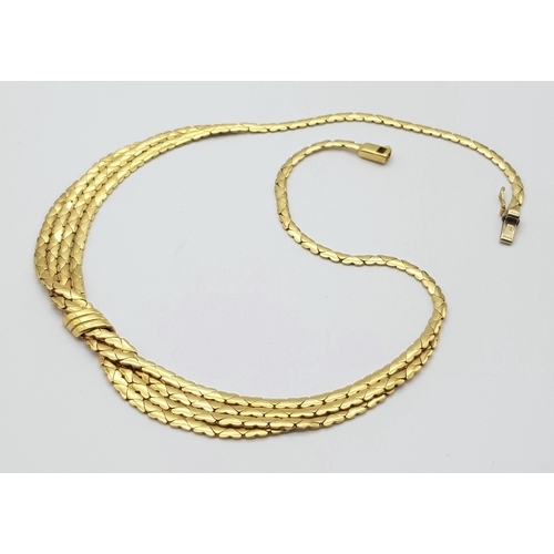 99 - A Stylish Italian 18K Yellow Gold Choker Necklace. A single to a four row centre with buckle decorat... 