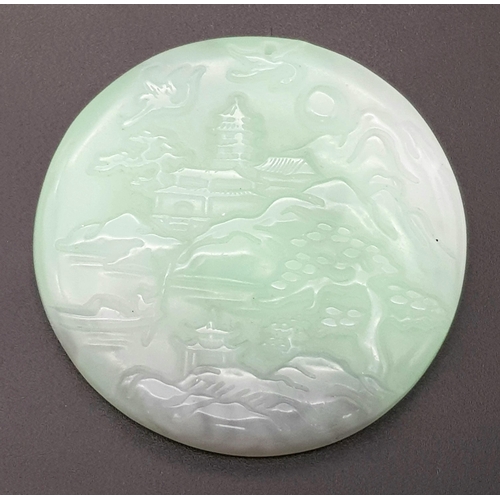 540 - A Chinese Pale Green and White Jade Circular Pendant with Village Decoration. 5cm diameter.