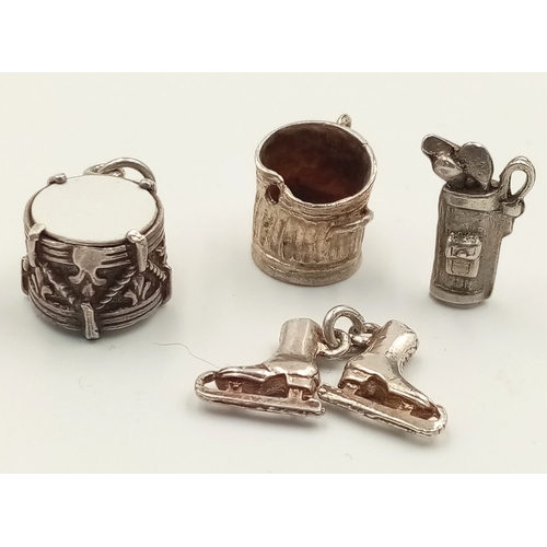 1694 - A SELECTION OF 4 X STERLING SILVER CHARMS - DUSTBIN, ICE SKATES, GOLF BAG WITH CLUBS, AND DRUM. 9g t... 