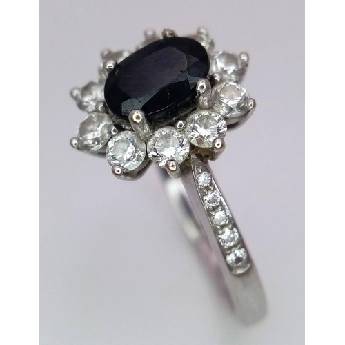 54 - A 18K (TESTED AS) WHITE GOLD DIAMOND & SAPPHIRE CLUSTER RING 0.50CT DIAMONDS & 1CT OVAL SAPPHIRE 4.8... 