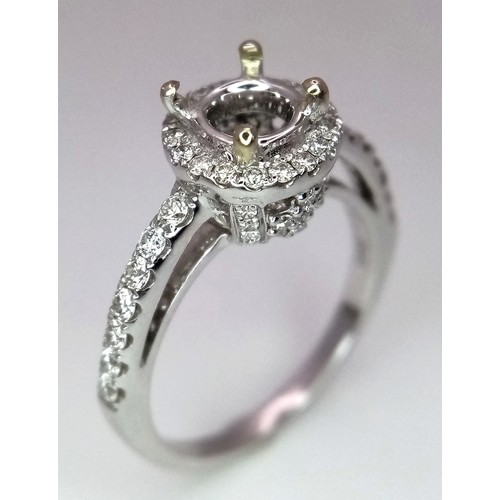 52 - AN 18K WHITE GOLD DIAMOND HALO SOLITAIRE RING MOUNT WITH DIAMOND SET SHOULDERS. Ready to set your dr... 