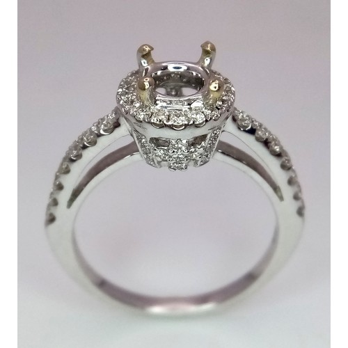 52 - AN 18K WHITE GOLD DIAMOND HALO SOLITAIRE RING MOUNT WITH DIAMOND SET SHOULDERS. Ready to set your dr... 