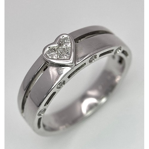 135 - A 18K WHITE GOLD DIAMOND RING, DIAMONDS SET IN HEART SHAPE CENTRE AND DIAMONDS SET ON TWO SIDE 4.9G ... 