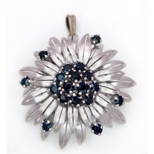 33 - A 14ct white gold (tested as) sapphire flower brooch that has a bail that can be worn as a pendant (... 