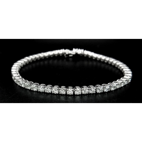 4 - A 18K WHITE GOLD DIAMOND TENNIS BRACELET 5.30CT OF WHITE BRILIANT CUT DIAMONDS 12.9G 17.7cm LENGTH

... 