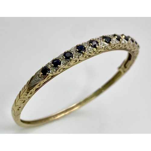 40 - A 9K YELLOW GOLD DIAMOND & SAPPHIRE SET BANGLE 10.4G , 55mm x 63mm diameter.

SC 9005