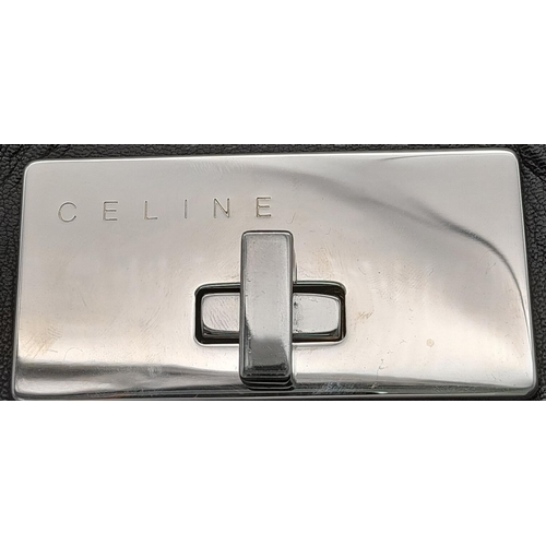 123 - A Celine Dark Brown Shoulder Bag. Leather exterior with silver-toned hardware, single strap, press s... 