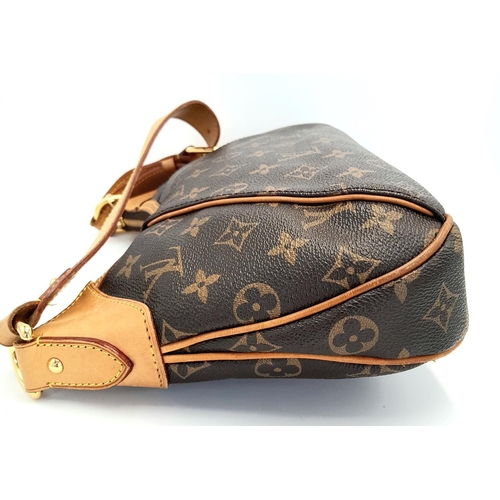 130 - A Louis Vuitton Thames Shoulder Bag. Monogramed canvas exterior with gold-toned hardware, adjustable... 