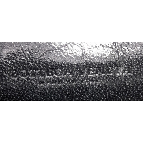 198 - A Bottega Veneta Black Bag. Intrecciato leather exterior with two rolled leather handles. Beige text... 