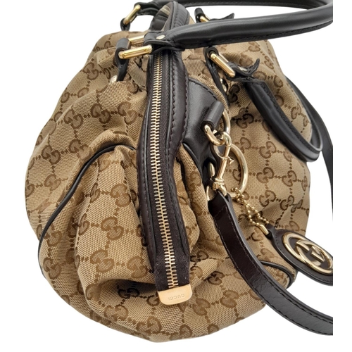 205 - A Gucci Monogram Sukey Satchel Bag. Canvas exterior with leather trim, two rolled leather handles, r... 