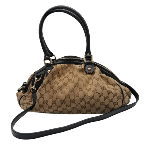 205 - A Gucci Monogram Sukey Satchel Bag. Canvas exterior with leather trim, two rolled leather handles, r... 