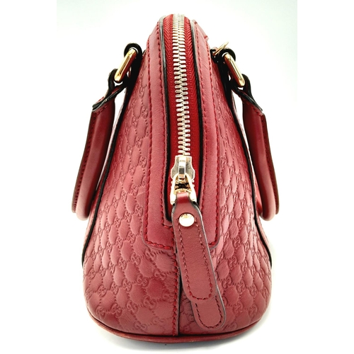 208 - A Gucci Red Guccissima Dome Bag. Monogramed leather exterior with gold-toned hardware, two rolled le... 