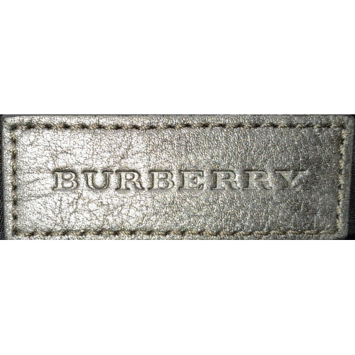 226 - A Burberry Metallic Grey Smoke Check Bag. Canvas exterior with leather trim, leather straps, black-t... 