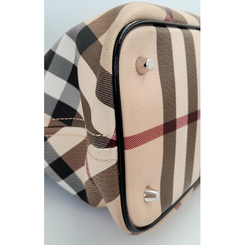 229 - A Burberry Beige Check Nova Bag. Coated canvas exterior with leather trim, two leather straps, silve... 