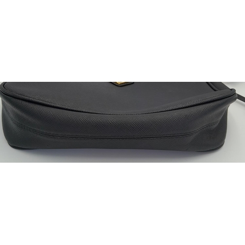 23 - A Prada Black Re-Edition 2005 Bag. Saffiano leather exterior with gold-toned hardware, zip top closu... 