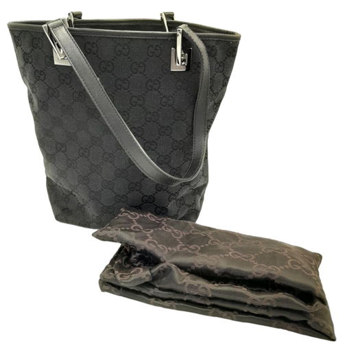 331 - A Gucci Black Monogram Tote Bag. Canvas exterior with leather trim, two leather straps and silver-to... 