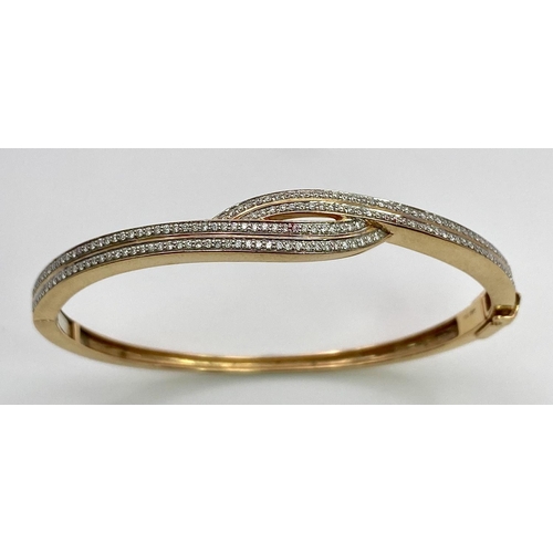 260 - A job lot of three 18 K yellow gold items, consisting of a diamond bangle with an elegant cross over... 