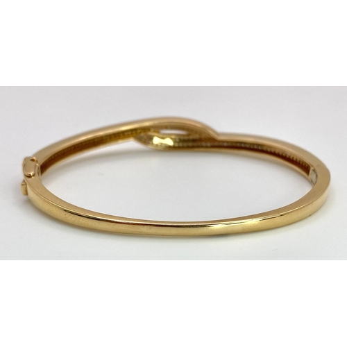 260 - A job lot of three 18 K yellow gold items, consisting of a diamond bangle with an elegant cross over... 