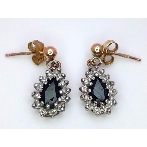 478 - A 9 K yellow & white pair of earrings with a tear drop sapphire surrounded by diamonds. Weight: 1.9 ... 