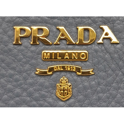 184 - A Prada Marine Blue Vitello Daino Shoulder Bag. Leather exterior with gold-toned hardware, adjustabl... 