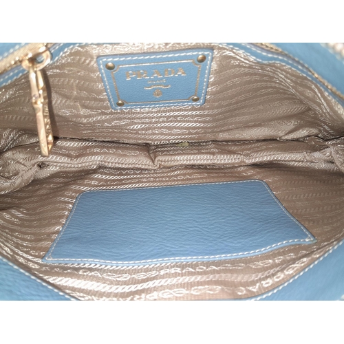 184 - A Prada Marine Blue Vitello Daino Shoulder Bag. Leather exterior with gold-toned hardware, adjustabl... 