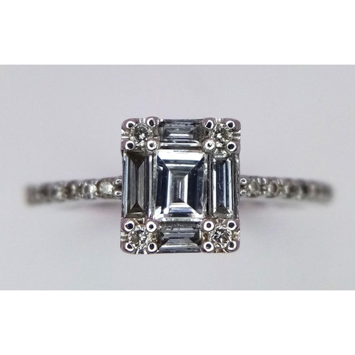 290 - An 18K White Gold, Rectangular, Baguette and Round Cut Diamond Ring. Size L 1/2. 2.8g total weight.