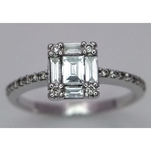 290 - An 18K White Gold, Rectangular, Baguette and Round Cut Diamond Ring. Size L 1/2. 2.8g total weight.