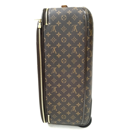 51 - A Louis Vuitton Monogram Pegase Suitcase. Durable leather exterior with gold-toned hardware. Front c... 