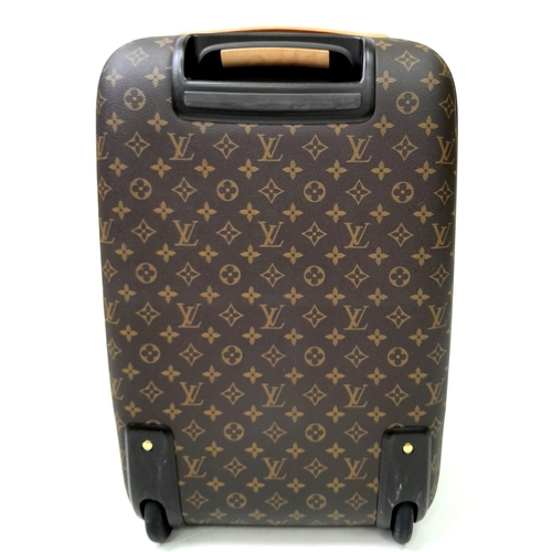 51 - A Louis Vuitton Monogram Pegase Suitcase. Durable leather exterior with gold-toned hardware. Front c... 