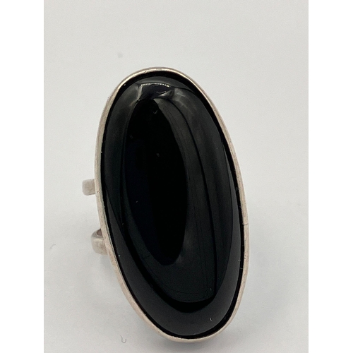 490 - Vintage SILVER and BLACK ONYX RING. Consisting a large oval Black Onyx set in a silver mount. The ri... 