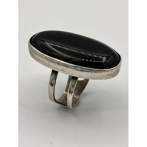 490 - Vintage SILVER and BLACK ONYX RING. Consisting a large oval Black Onyx set in a silver mount. The ri... 