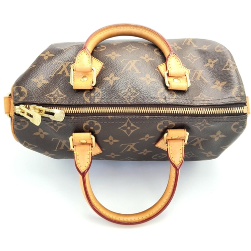 177 - A Louis Vuitton Speedy Bag. Monogramed canvas exterior with gold-toned hardware, two rolled leather ... 