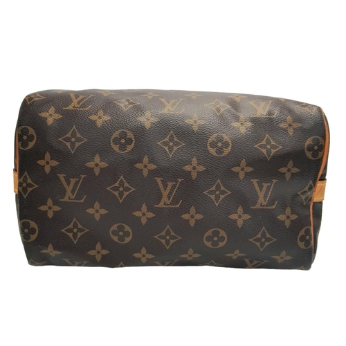 177 - A Louis Vuitton Speedy Bag. Monogramed canvas exterior with gold-toned hardware, two rolled leather ... 