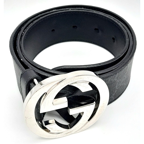 191 - A Gucci Black with Grey Monogram Men's GG Belt. Silver-toned hardware. Approximately 104.5cm length,... 