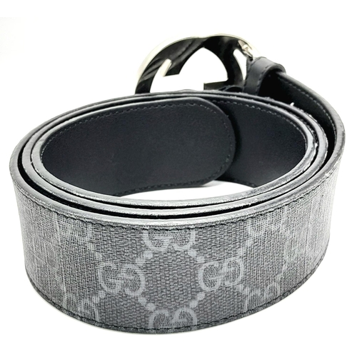 191 - A Gucci Black with Grey Monogram Men's GG Belt. Silver-toned hardware. Approximately 104.5cm length,... 