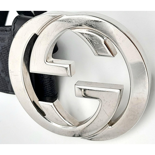 191 - A Gucci Black with Grey Monogram Men's GG Belt. Silver-toned hardware. Approximately 104.5cm length,... 