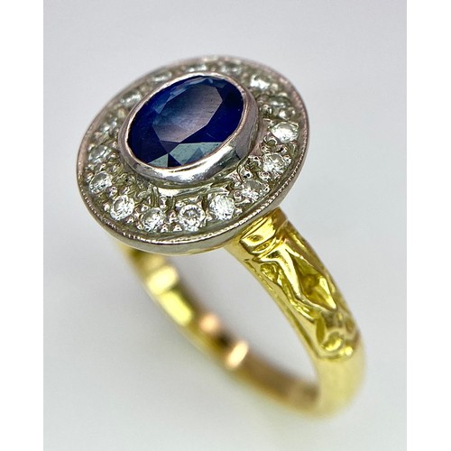 267 - An 18 K yellow gold ring with an oval cut blue sapphire surrounded by a halo of round cut diamonds a... 