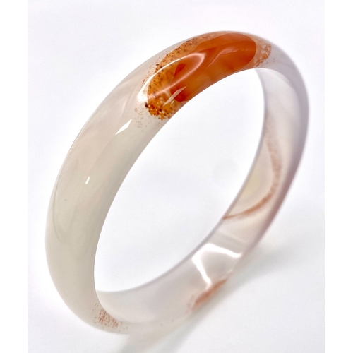 1692 - A White and Red Jade Bangle. 6cm inner diameter.