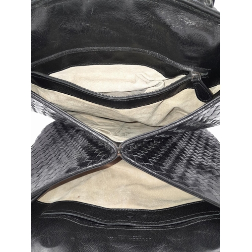 138 - A Bottega Veneta Black Bag. Intrecciato leather exterior with two rolled leather handles. Beige text... 
