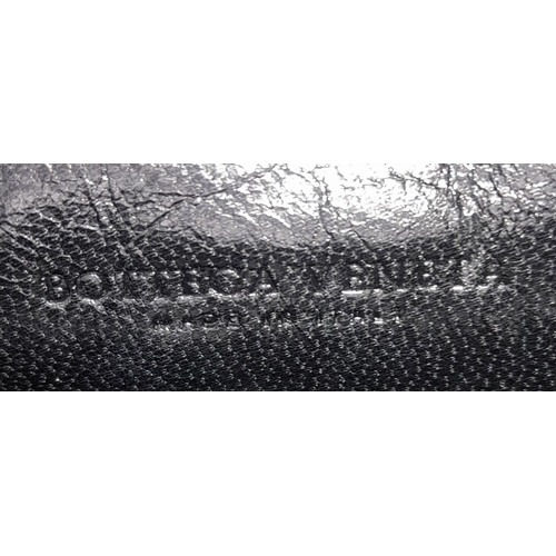 138 - A Bottega Veneta Black Bag. Intrecciato leather exterior with two rolled leather handles. Beige text... 